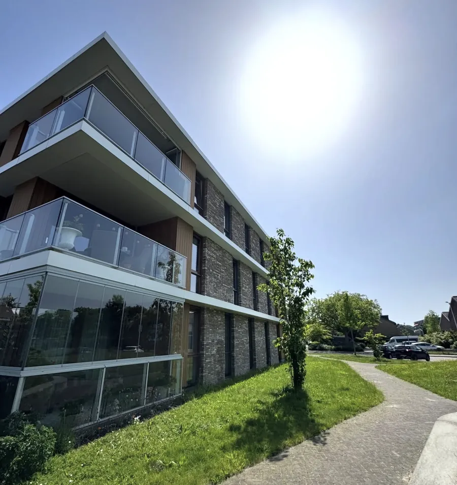 Hoek van het VvE-complex met glazen balkonhekken